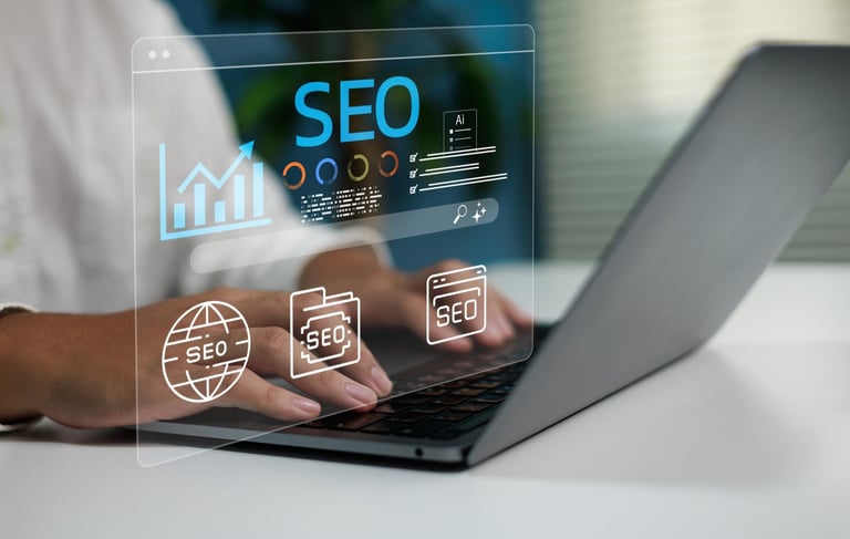 Person using laptop with holographic SEO icons and analytics dashboard displaying search engine optimization data